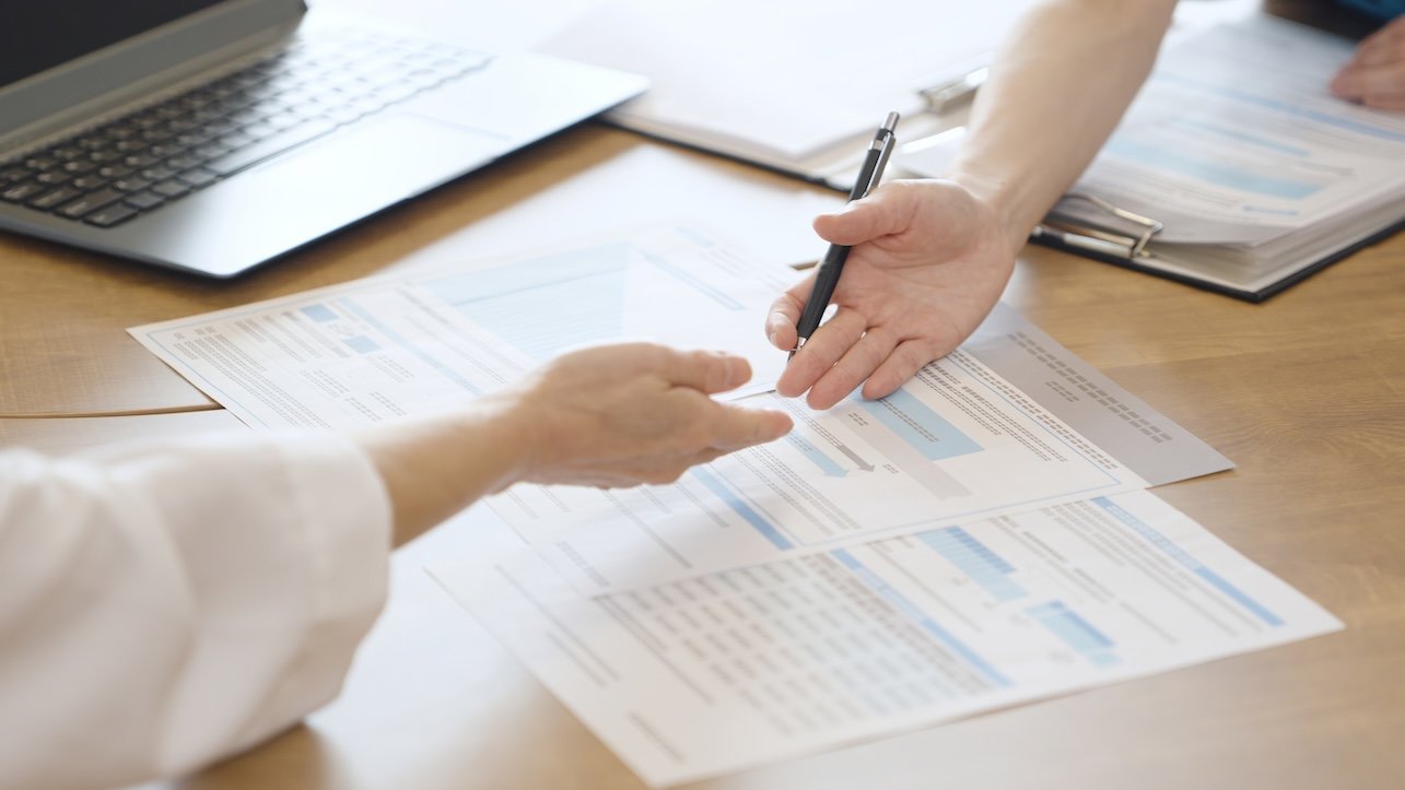 Caregiver explaining about medical care costs to a worried patient